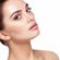 Close-up of a woman with clear skin, featuring dotted lines and arrows suggesting facial rejuvenation or skincare treatment. white background.